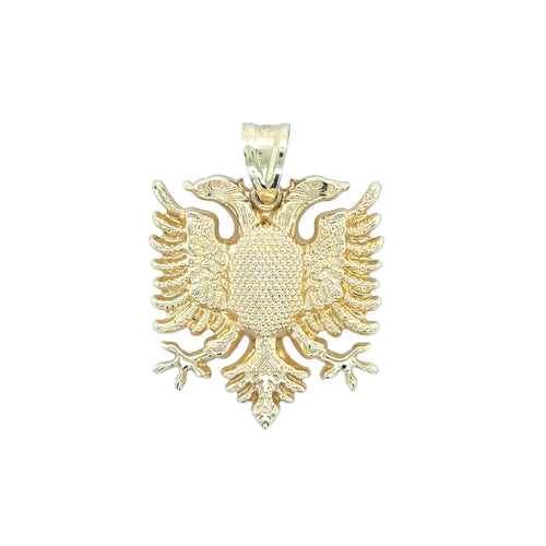 Gold double-headed eagle pendant on a white background