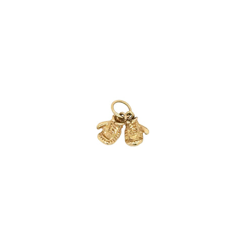Gold charm with two faces on a white background