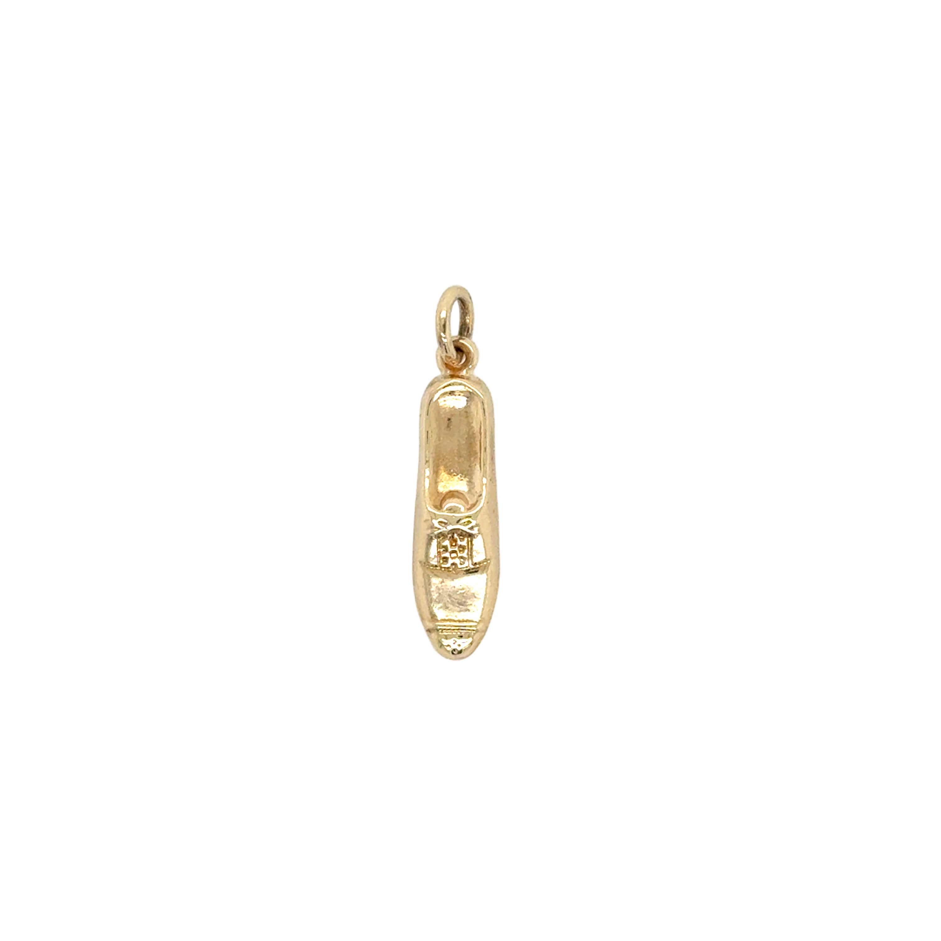 Gold shoe charm on a white background