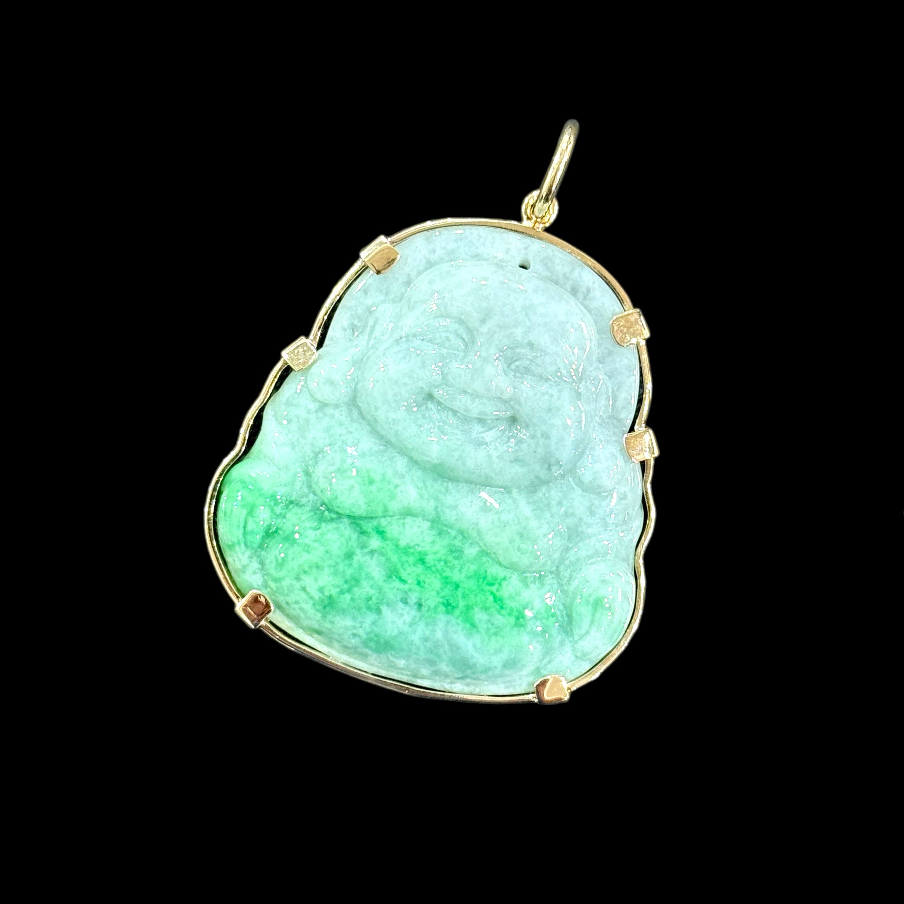 Green jade pendant with gold frame on a black background
